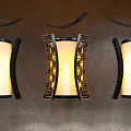 Traditional Chinese Style Chandeliers With Yellow Illuminated Shades And Black Lattice Frames On Textured Wall