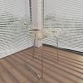 Transparent Glass Stool With Metal Legs In Room With Wooden Floor And Sunlight