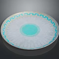 Circular Carved Sculpture Plate with Blue Geometric Patterns and Central Blue Circle on White Surface