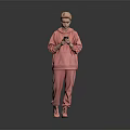 Woman In Pink Hoodie And Pants Holding Phone Against Gray Background With Black Floor Reflection