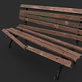 Worn Outdoor Bench With Damaged Wooden Planks Metal Legs And Green Graffiti