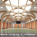 Indoor Basketball Court Featuring Arched Wooden Roof Skylights Scoreboard Wooden Panel Walls And Green Floor