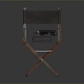 Vintage Wooden Director's Chair With Classic Typewriter Resting On Seat Surface