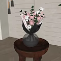 Silver Vase With Pink Roses White Cotton Black Wrapped Bouquet on Round Wooden Table