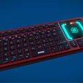 Red Backlit Computer Keyboard With Green Glowing Area and Standard Key Layout