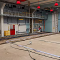 Cartoon Style Industrial Workshop Scene With Concrete Floor Metal Railings And Red Pendant Lights