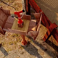 Outdoor Fire Safety Equipment With Red Fire Extinguisher On Wooden Platform And Stone Pavement