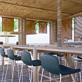 Outdoor Restaurant With Thatch Roof Poolside Palm Trees And Umbrella Seating