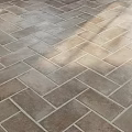 Earthy Brown Herringbone Tile Floor With Textured Surface And Natural Light Shadows