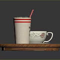 Wooden Tray Holding Drink with Straw and Patterned Teacup on Small Saucer