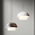 Two Dome Shaped Modern Pendant Lights Textured Shades With White Illuminated Light Against Minimalist Gray Wall