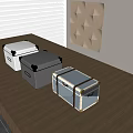 Three Storage Boxes White Gray Blue with Metal Corners Leather Straps on Wooden Table
