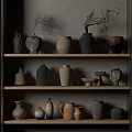 Collection of Assorted Ceramic Vessels on Wooden Shelves with Decorative Branches and Neutral Hues