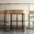 Elegant Gold Framed Glass Revolving Door With Green Plant And Marble Floor Interior