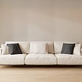 Modern Three Seater Cream Sofa with Striped and Plain Cushions in Light Brown Room Setting