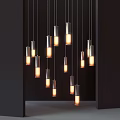 Modern Cylindrical Metallic Pendant Lights with Warm Glowing Light Clustered Against Dark Backdrop
