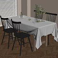 Stylish Dining Table With White Tablecloth Black Chairs And Green Plant Decoration