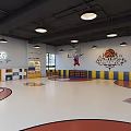 Well Lit Basketball Gym With Multiple Hoops Themed Flooring And Bright Ceiling Lights