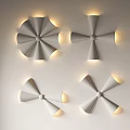 Modern Geometric Flower Shaped Wall Sconces With Warm Light On White Wall
