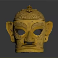 Intricate Golden Mask Sculpture With Detailed Carving Patterns And Decorative Top