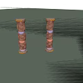 Two Colorful Traditional Totem Poles With Carved Human Faces And Ornate Tops