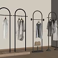 Golden Clothing Racks With Hanging Clothes And White Bag In Modern Interior