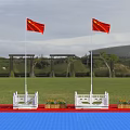 Two Chinese National Flags Flying on White Flagpoles Green Grassland Red Carpet and Yellow Flowers