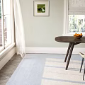 Light Gray Upholstered Dining Chairs With Black Metal Legs By Wooden Round Table And Vase