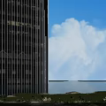 Modern Office Buildings With Tall Twisted Design Glass Curtain Walls Against Blue Sky White Clouds