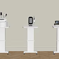 Three White Medical Devices Placed on Mobile Wheeled Stands in Clinical Environment