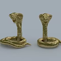 Two Golden Cobra Reptile Statues With Coiled Bodies And Raised Heads