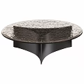Modern Round Coffee Table With Textured Surface And Black Base Design