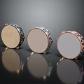 Three Musical Tambourines With Metal Frames And Different Drumheads On Reflective Surface
