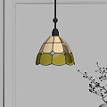 Stained Glass Pendant Light With Yellow Patterns Hanging Over White Wall And Twig Vase