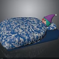 Blue Cushion Featuring White Geometric Pattern And Small Doll With Pink Hat