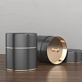 Black Gold Accent Cylindrical Decorative Ornament Set With Open Lid On Wooden Tabletop