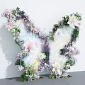Butterfly Shaped Art Installation With Pink White Purple Flowers Green Leaves and Transparent Wings