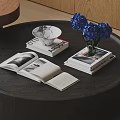Open Books and Magazines on Dark Wooden Table with White Bowl and Blue Hydrangeas