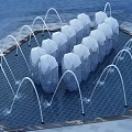 Neatly Arranged Garden Ornament With Transparent Objects And Curved Water Jets On Blue Ground