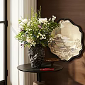 Black Textured Vase With White Purple Flowers On Dark Table Near Round Decorative Mirror