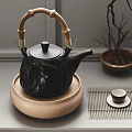 Elegant Black Teapot With Bamboo Handle And Beige Base Including Tea Cups On Bamboo Mat