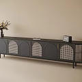 Black TV Cabinet with Arched Lattice Doors Slim Legs and Vase Radio Book on Top