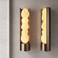 Modern Wall Sconces With Metal Frame And Glowing Irregular Shaped Globes On Gray Wall Interior