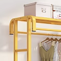 Gold Rolling Clothing Rack With Hanging Folded Clothes And Shoes