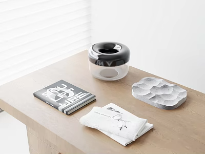 Black And White Circular Inflatable Device On Wooden Table With Magazine Towel And Gray Tray 3d model