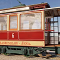 Red and Beige Tram Number 6 with White Curtains Green Undercarriage on Rail Tracks Jena