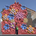 Vibrant Floral Art Installation With Pink Blue Yellow Flowers Outdoor Family Posing In Front
