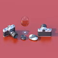 Decorative Ornament Set With Two Camera Models Wine Glass And Stones On Red Background