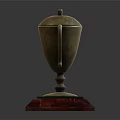 Golden Trophy With Curved Handles Lid And Red Transparent Base For Champion First Place