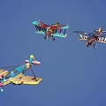 Three Colorful Vintage Biplane Fighter Planes Flying Together in Blue Sky
